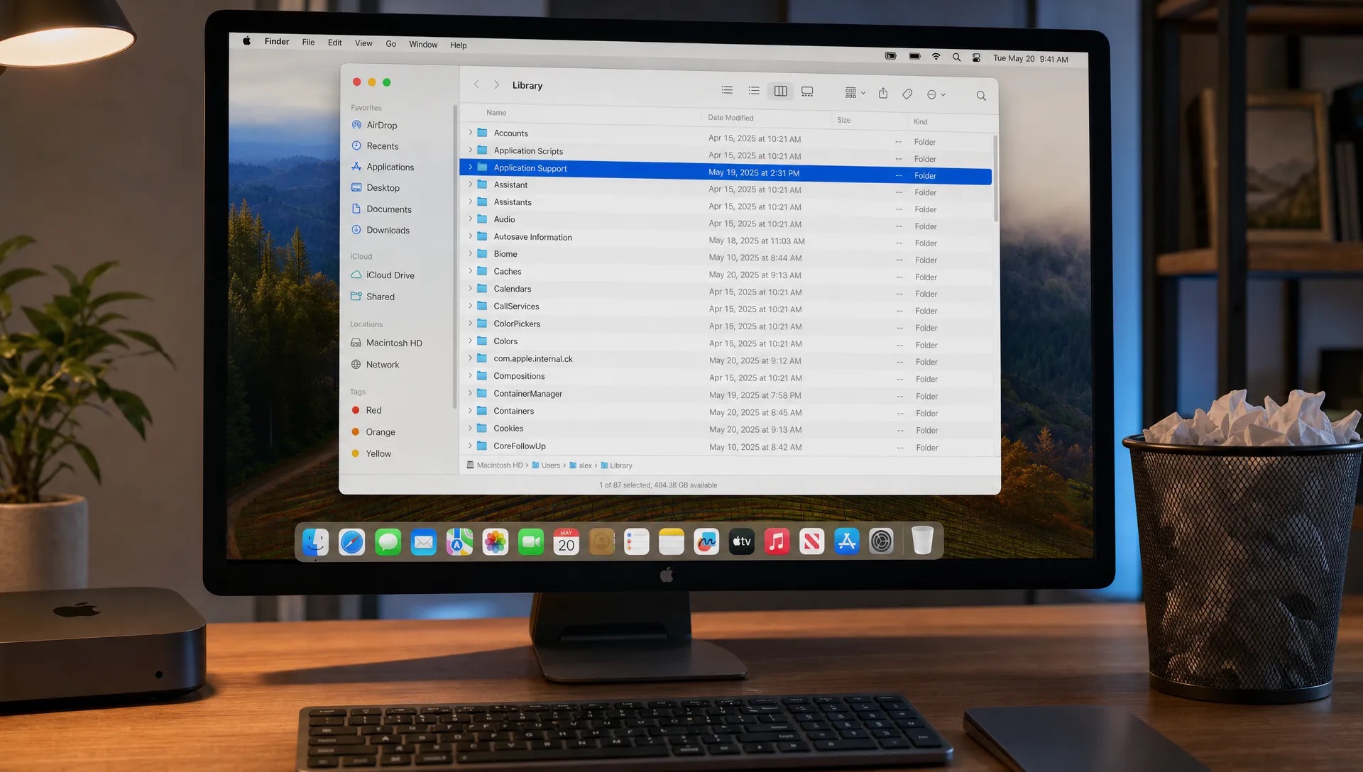 A Finder window on a Mac shows Library folders, app support files and a Trash bin during leftover cleanup.