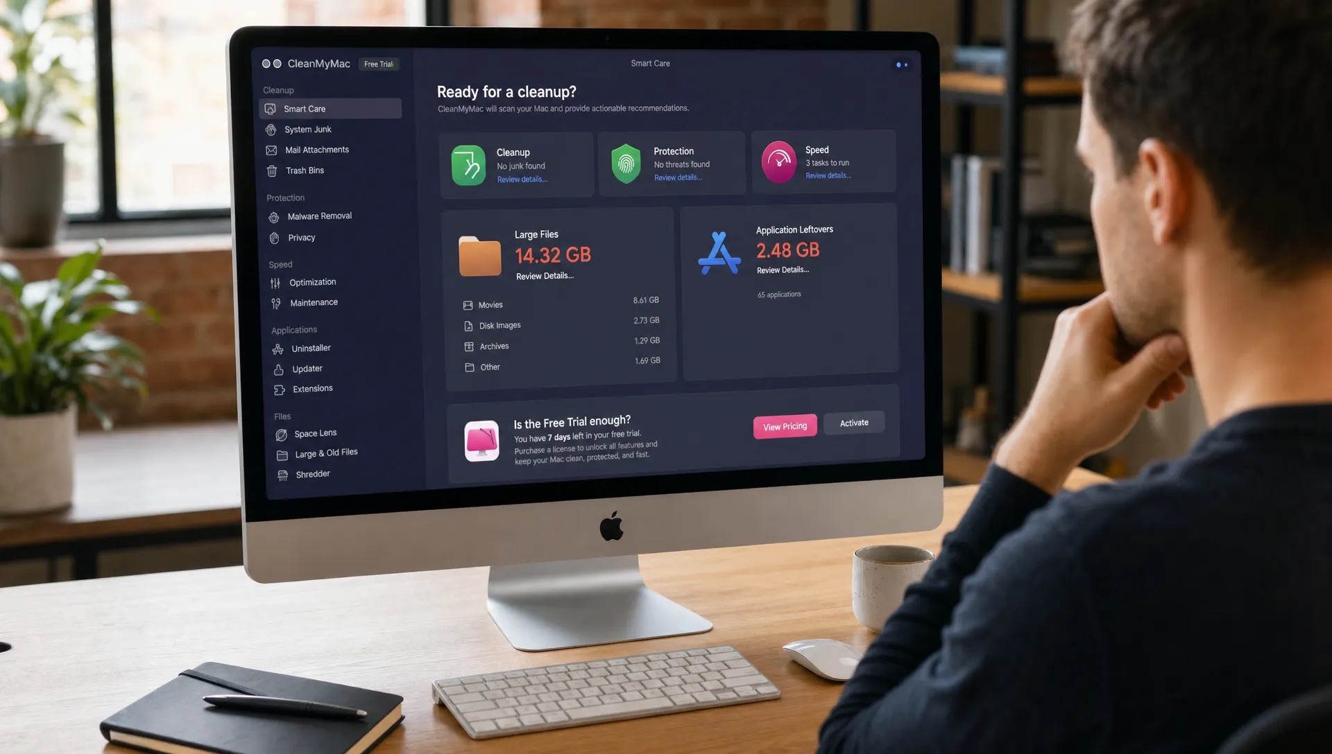 A Mac desktop shows file categories, large files and app leftovers while someone checks whether the CleanMyMac free trial is enough.